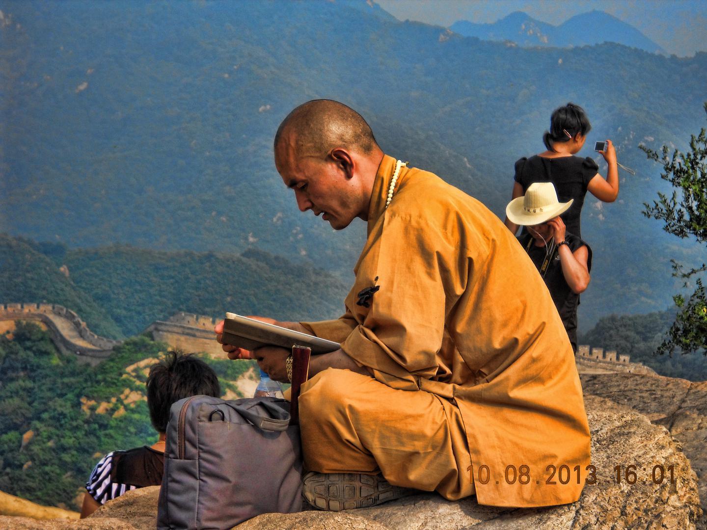 A monk sitting on the wall